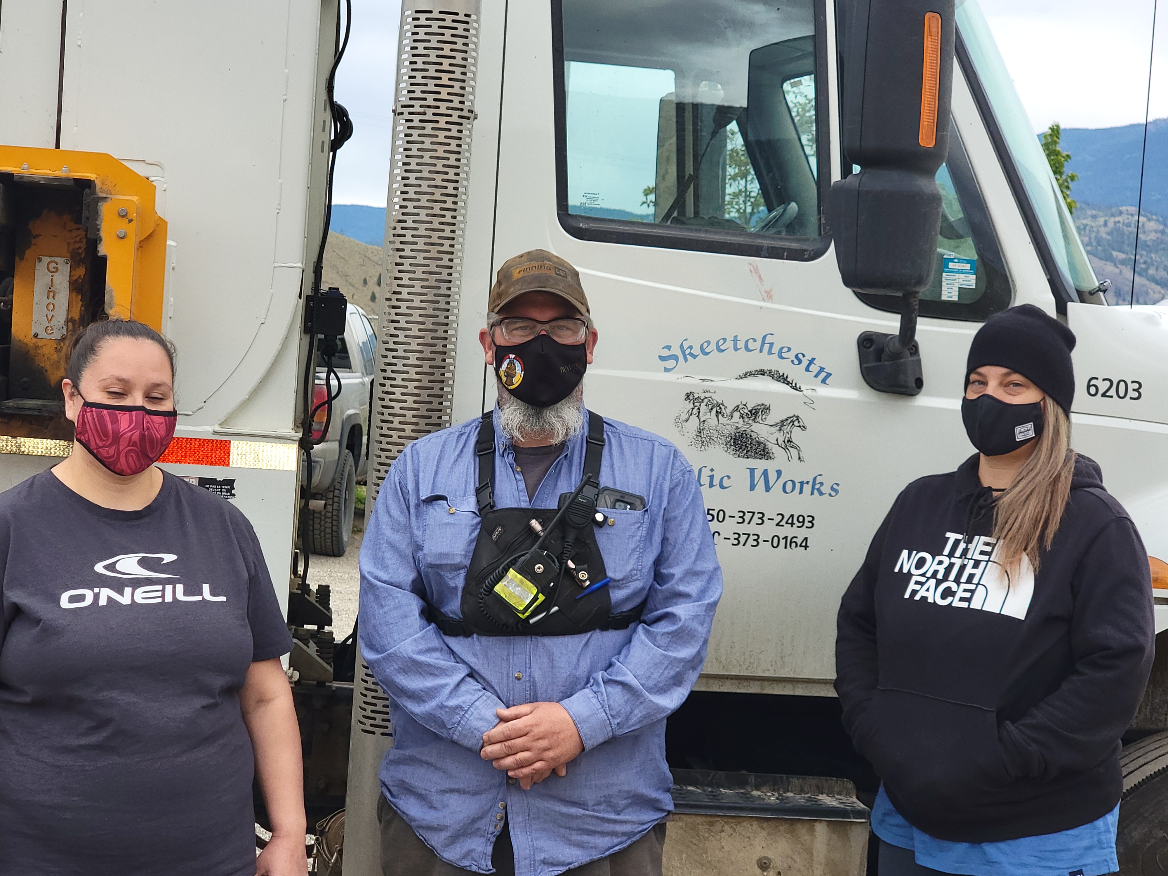 three members of the Skeetchestn recycling team standing in front of the collection truck