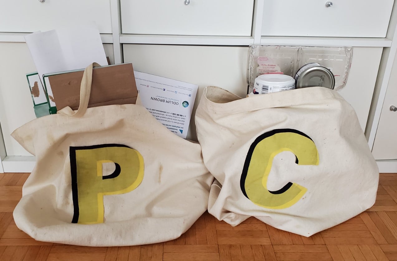 Canvas bags painted with letter P and C to sort paper and container recycling