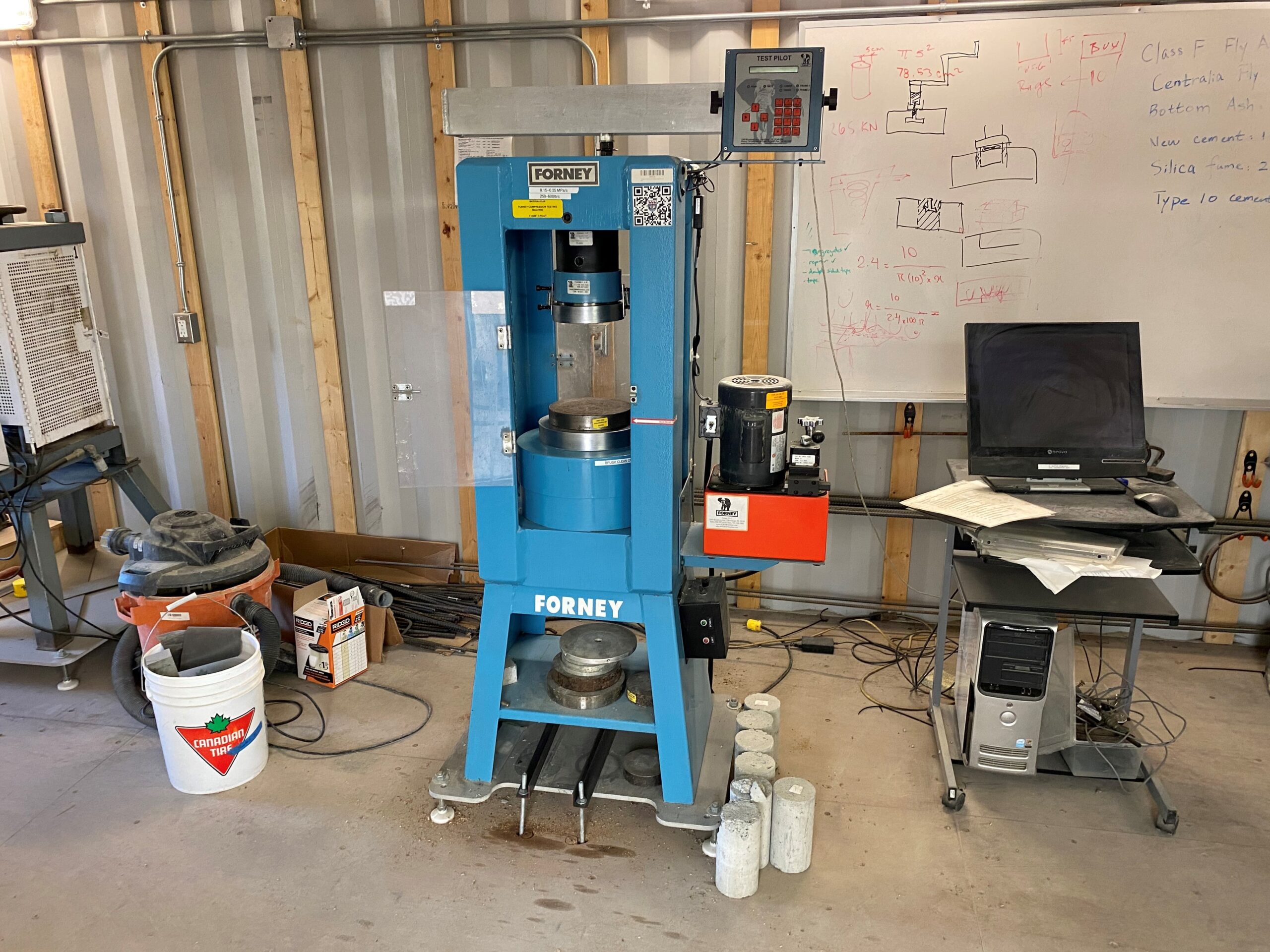 Industrial set up to test the strength of solidified concrete in laboratory